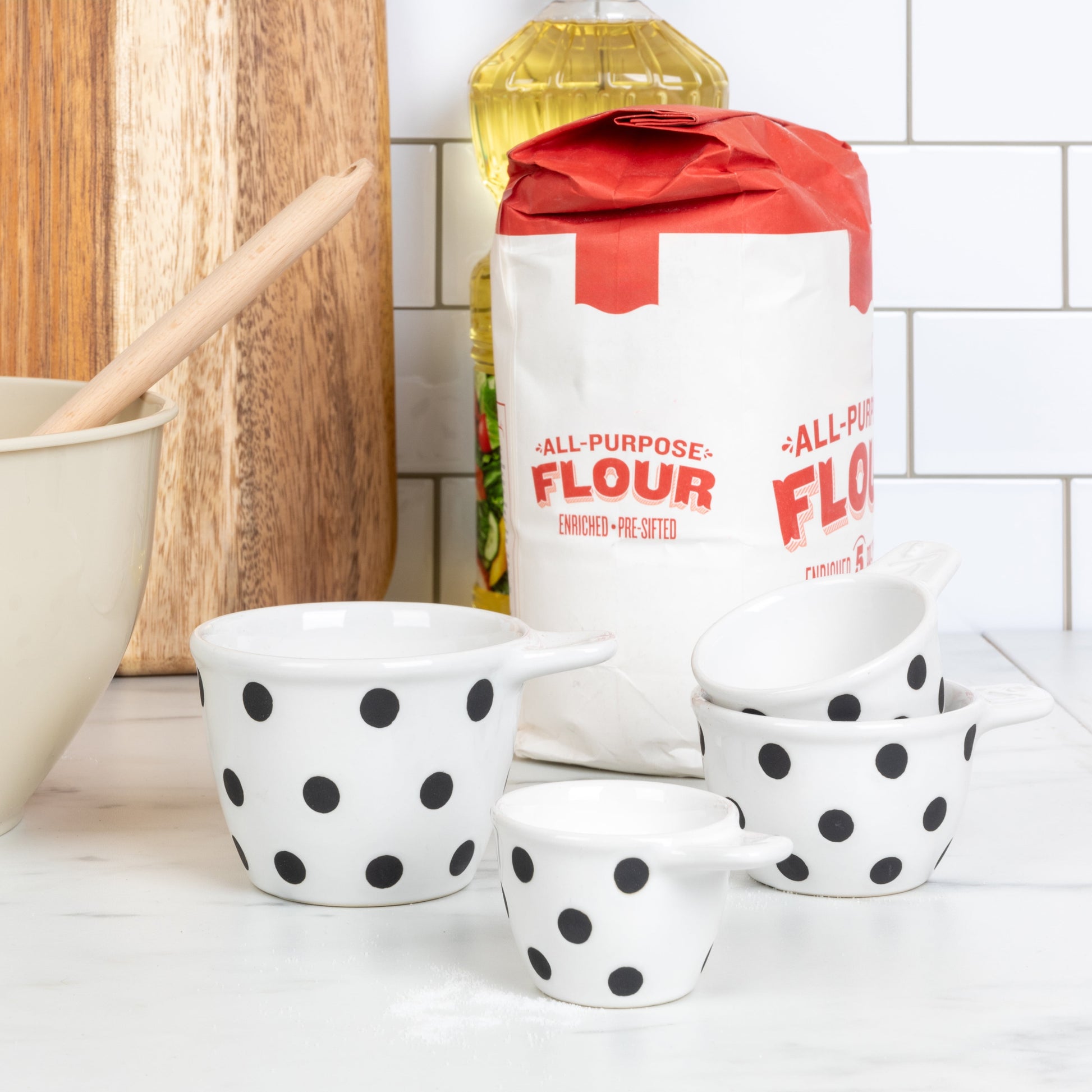 Creative Co-Op Ceramic Measuring Cups with Polka Dots, Set of 4 Sizes, Black and White